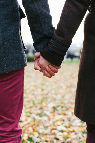 Closeup of young couple in love holding hands - Photo, Image