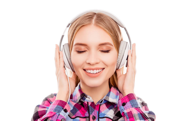 Attractive calm woman relaxing and listening music in headphones - Фото, зображення