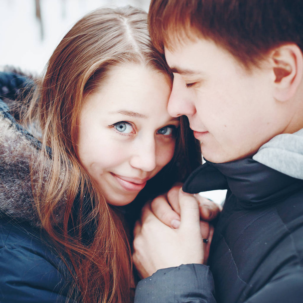 Loving couple in winter forest - Zdjęcie, obraz