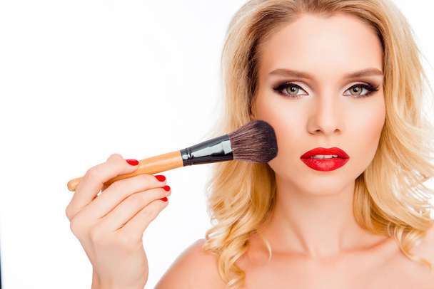 Pretty young woman doing makeup with powder  brush - Photo, Image
