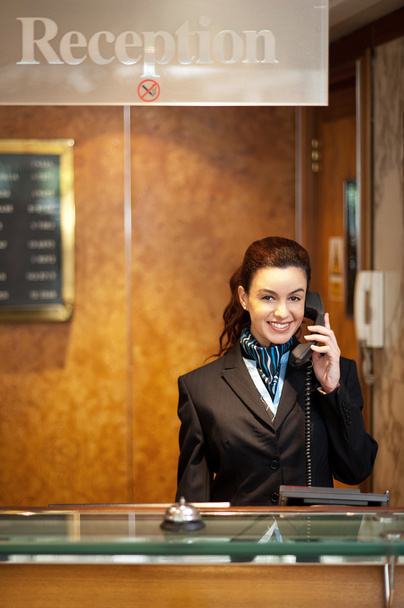Attractive young receptionist receiving calls - Fotoğraf, Görsel