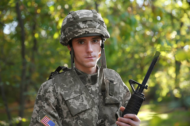 Portrait of soldier with rifle in forest - Zdjęcie, obraz
