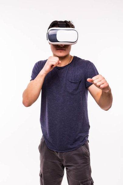portrait of young excited man experiencing virtual reality isolated on white background - Foto, afbeelding