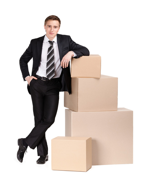 Manager stands near pile of pasteboard boxes - Photo, Image