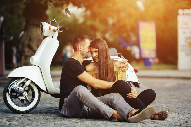 Cute couple with their scooter in the city - Foto, immagini