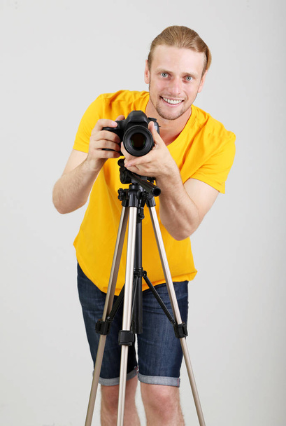 Handsome photographer with camera - Photo, image