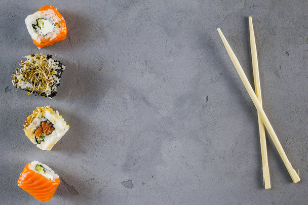 Set of traditional Japanese sushi on a dark background. Top view with a copyspace - Photo, Image