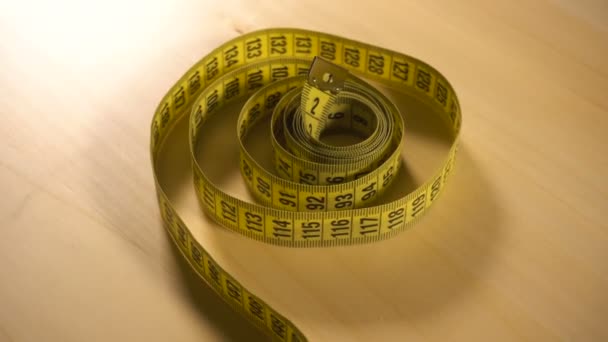 Yellow measuring tape spinning around - Footage, Video