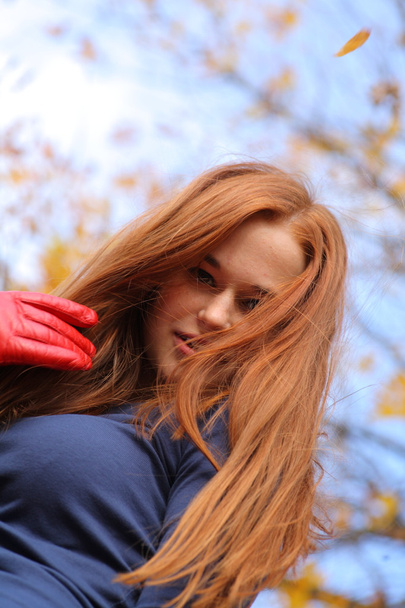 Close-up portrait of a beautiful red-headed girl posing - 写真・画像