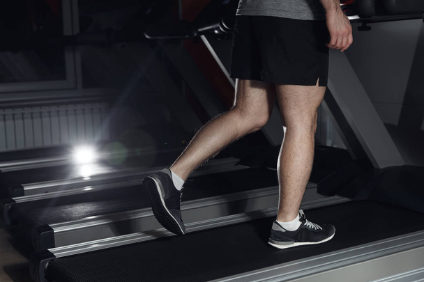 Man running in a gym on a treadmill concept for exercising, fitness and healthy lifestyle. - 写真・画像