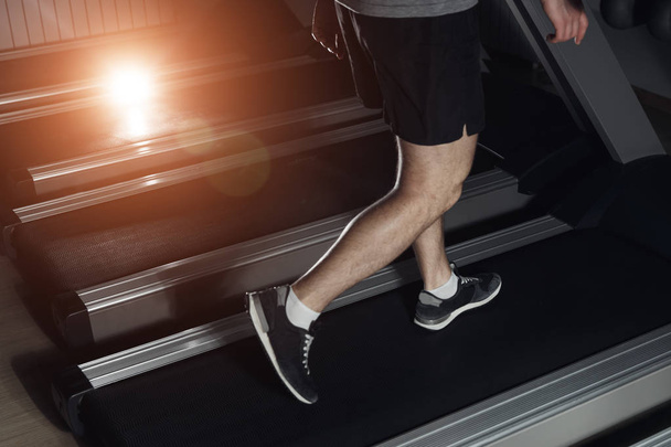 Beine des Sportlers laufen auf dem Laufband: Sport und gesundes Lifestyle-Konzept. - Foto, Bild