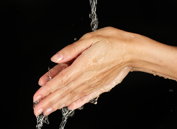 Washing hands on black background close-up - Photo, Image