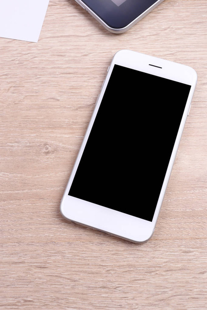 Blank screen smartphone and tablet on wooden background - Φωτογραφία, εικόνα