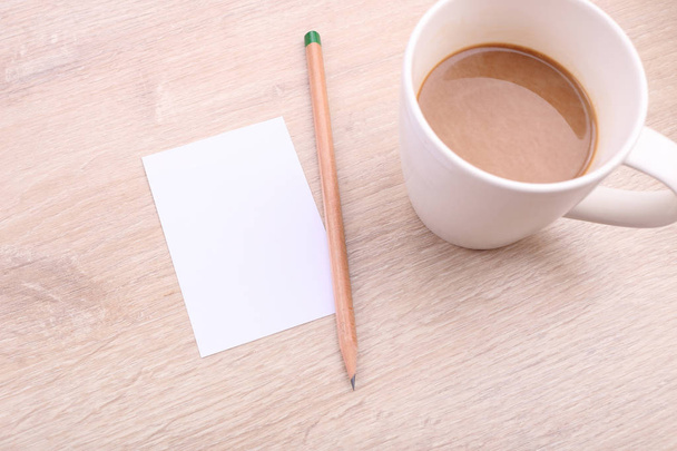 Coffee with paper note and pencil on wooden background - Photo, image