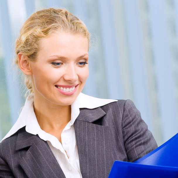 Portrait of happy smiling businesswoman at office - Fotografie, Obrázek