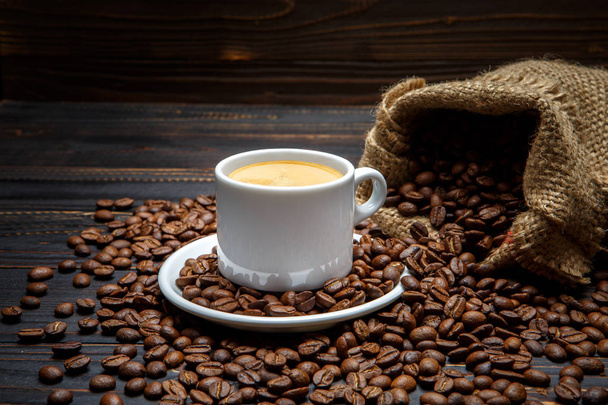 cup of coffee and beans on wooden background - Φωτογραφία, εικόνα