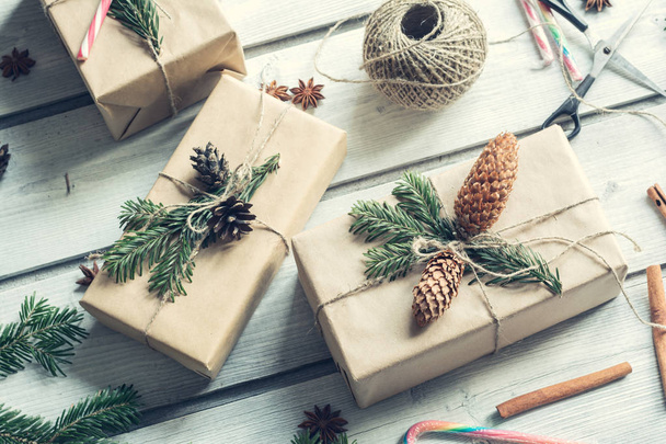Gift boxes decorated fir cone and spruce branch. Background for Christmas and New year - Φωτογραφία, εικόνα