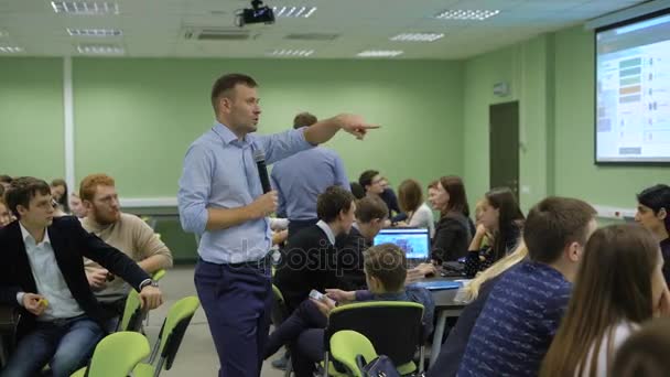 The practical classes at the University. Teacher presentation teaches students the basics of their subject. Students carefully listen to him. - Footage, Video