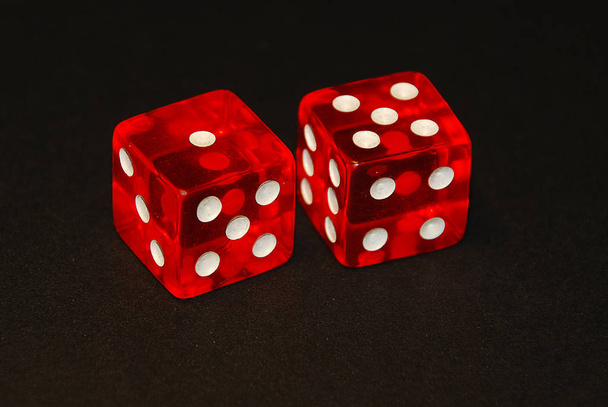 two dice on a black desk, result six (6), one (1) and five (5)
) - Фото, изображение