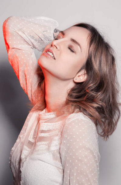 Studio portrait of amazing girl with color red light. - Fotó, kép