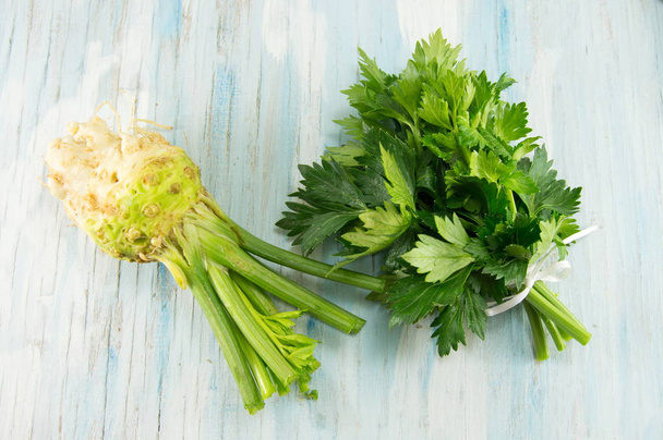 whole celery on a white cutting board - Photo, Image