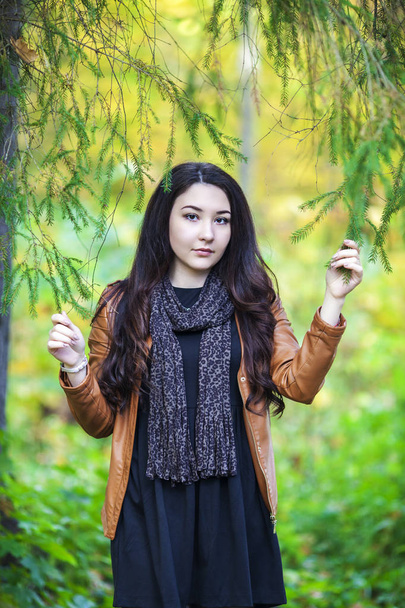 Portrait of a beautiful Russian girl in autumn park - Foto, Imagen