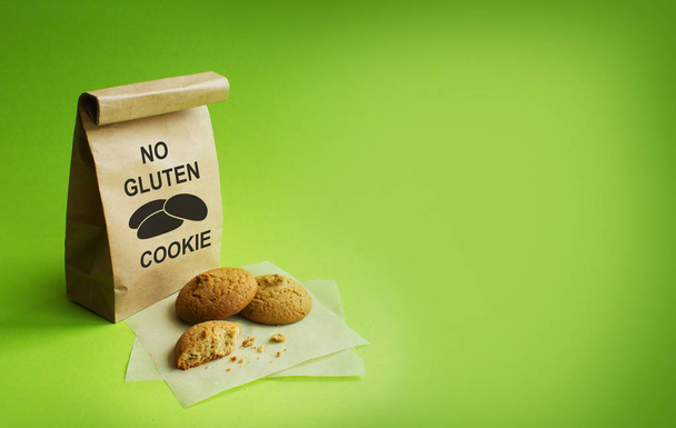 Gluten-free cookies in the kraft bag. Green background - Photo, Image