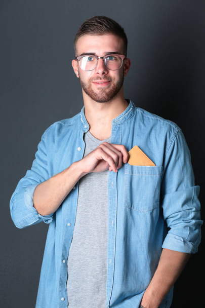 Man holding a credit card , isolated on black background - Photo, Image