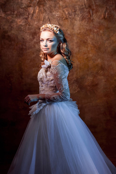 Beautiful girl bride in luxurious wedding dress, portrait in profile, effects of glare - Zdjęcie, obraz