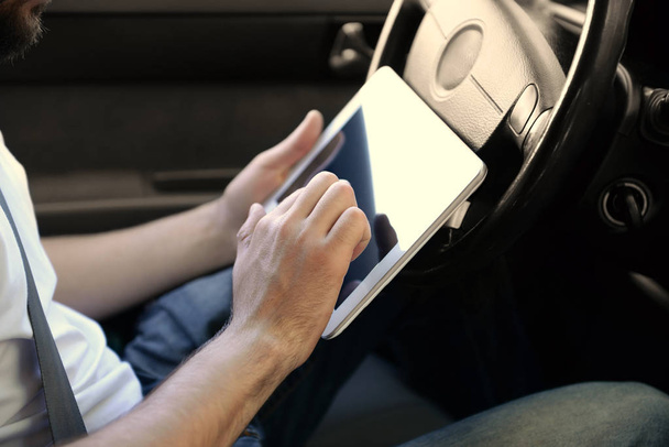 Young male driver using tablet computer - Photo, image