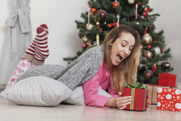 woman with christmas box gift in front of Christmas tree - Photo, Image