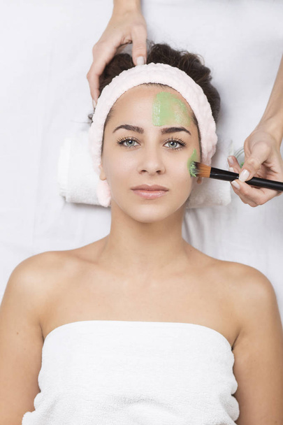 woman in a spa with algae facial mask - Photo, Image