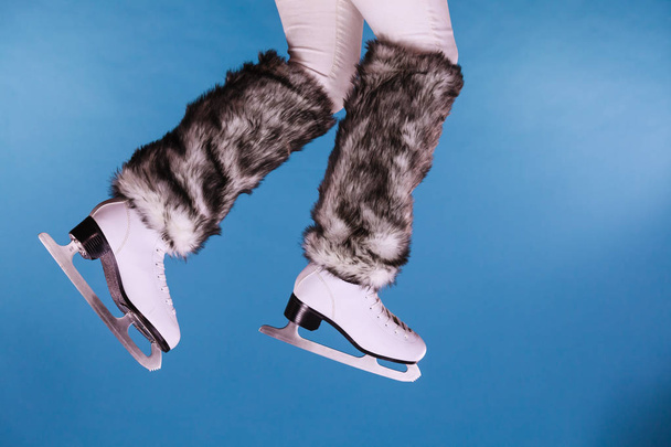 Woman legs wearing ice skates fur socks, skating  - Foto, afbeelding