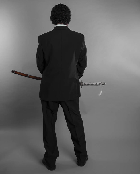 Aggressive businessman with Japanese swords - Фото, зображення