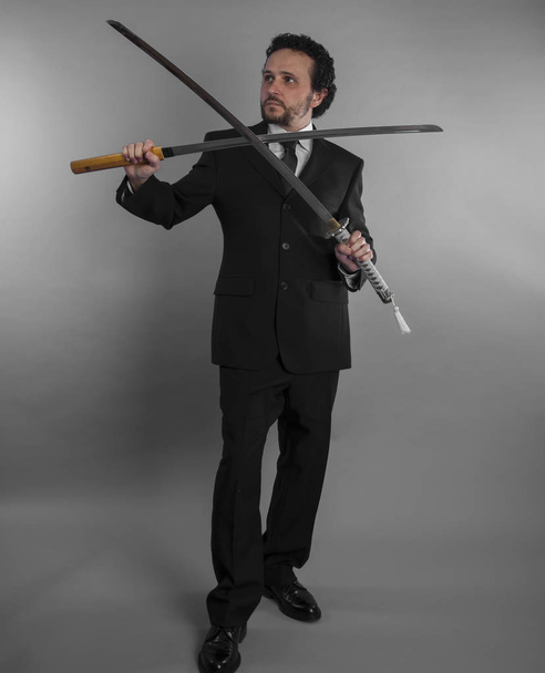 Aggressive businessman with Japanese swords - Photo, image