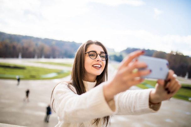 girl taking selfie on garden background - Photo, Image
