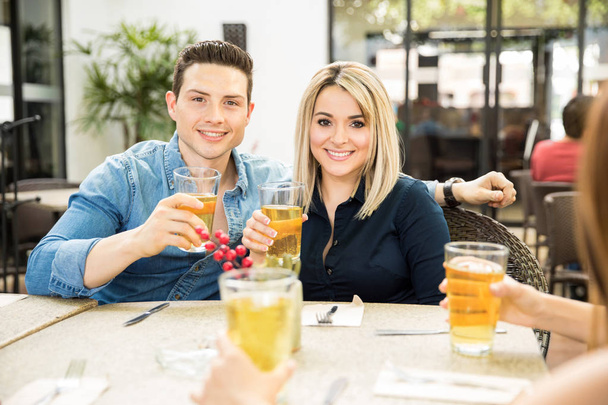 Couple drinking beer in a restaurant - Фото, зображення