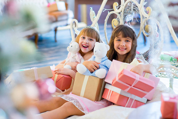 Two adorable girls with Christmas gifts - Photo, Image