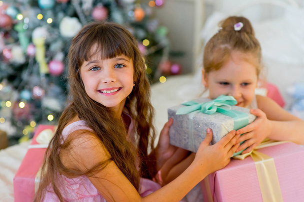 Two young girls give each other gifts - 写真・画像
