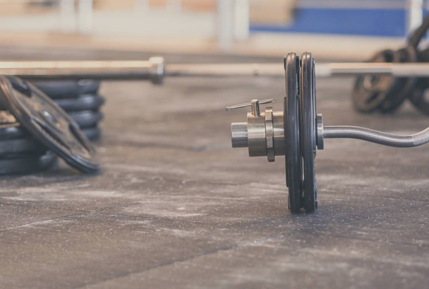 Barbell on floor in gym - Foto, immagini