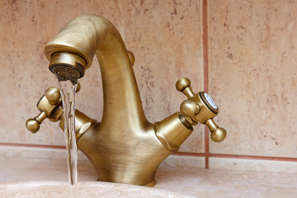 Water flowing from vintage or retro faucet - Photo, Image