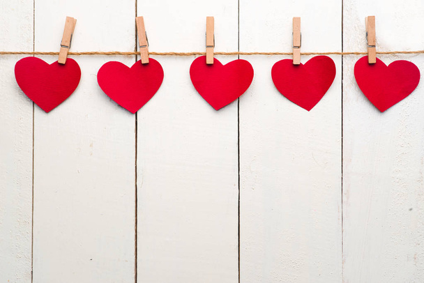 Red hearts hanging on clothesline  - Photo, Image
