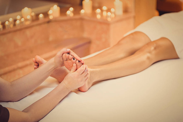 Young woman enjoying foot treatment - Fotografie, Obrázek