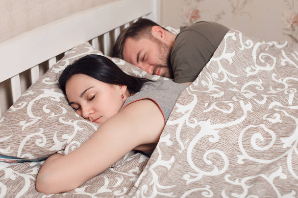 man and woman sleeping in bed - Photo, Image