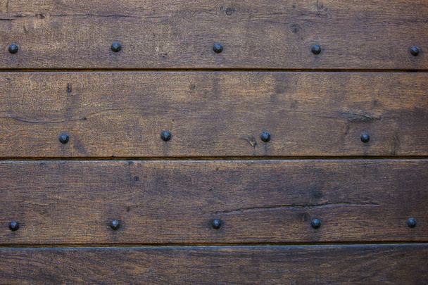 Weathered wooden door texture with nail heads - Photo, Image