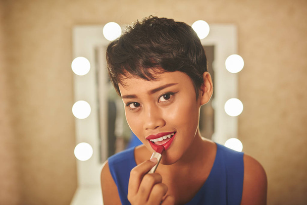 Woman applying red lipstick - Photo, Image