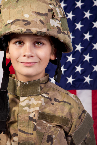 Boy USA soldier in front of American flag. - Foto, Imagen