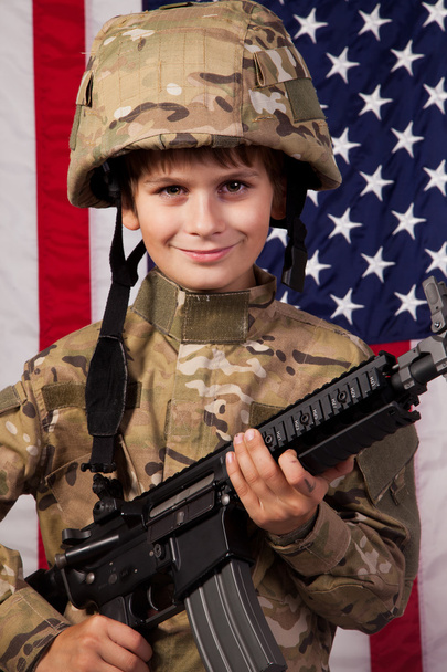 Boy USA soldier in front of American flag with rifle - Foto, Imagem