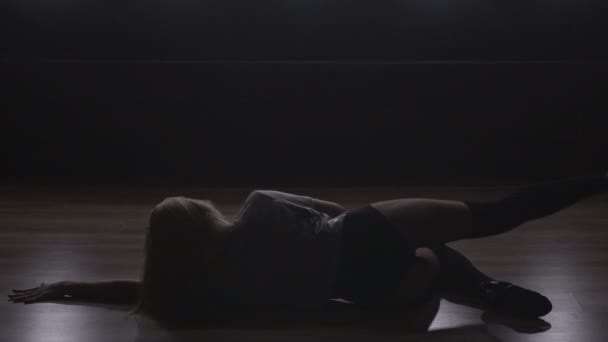 Silhouette of a girl dancing on the background lights. Slow motion - Materiał filmowy, wideo