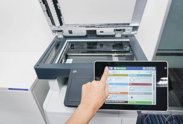 woman press forefinger on the printer touch screen to print documents - Photo, Image